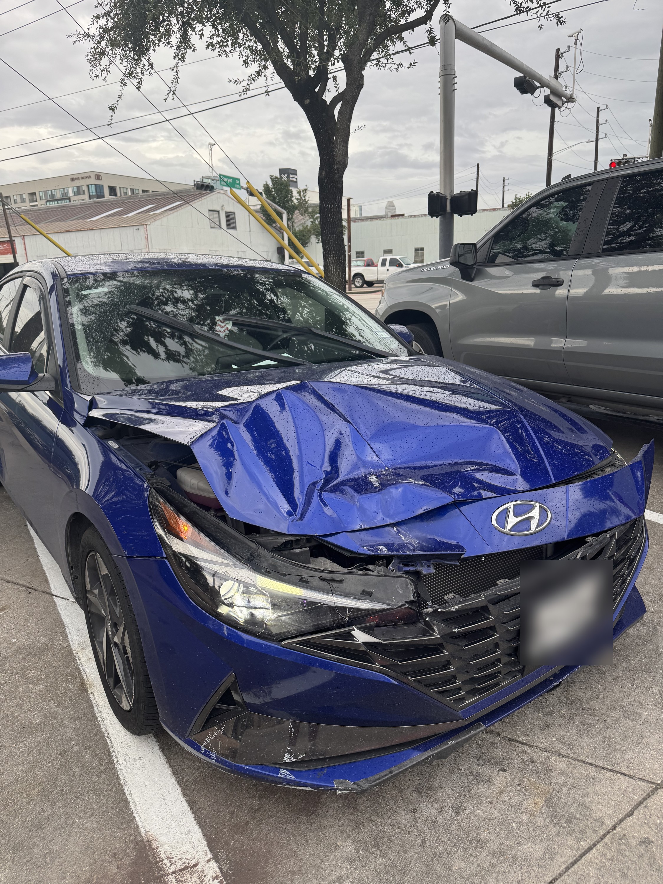 Blue Hyundai Elantra with front-end collision damage before repair