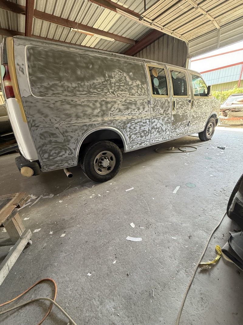 White work van in body filler and prep during bodywork at INC Collision